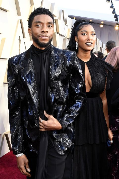 Taylor Simone Ledward and her late husband Chadwick Boseman twinning in a black dress.